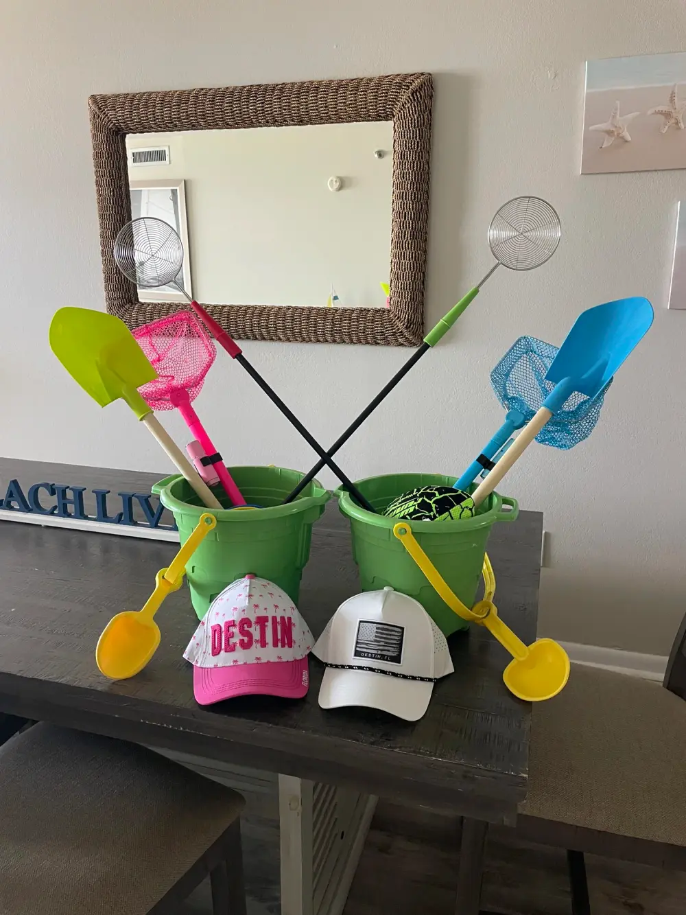 A Sand Essentials beach gift basket with bucket, shovel, and net